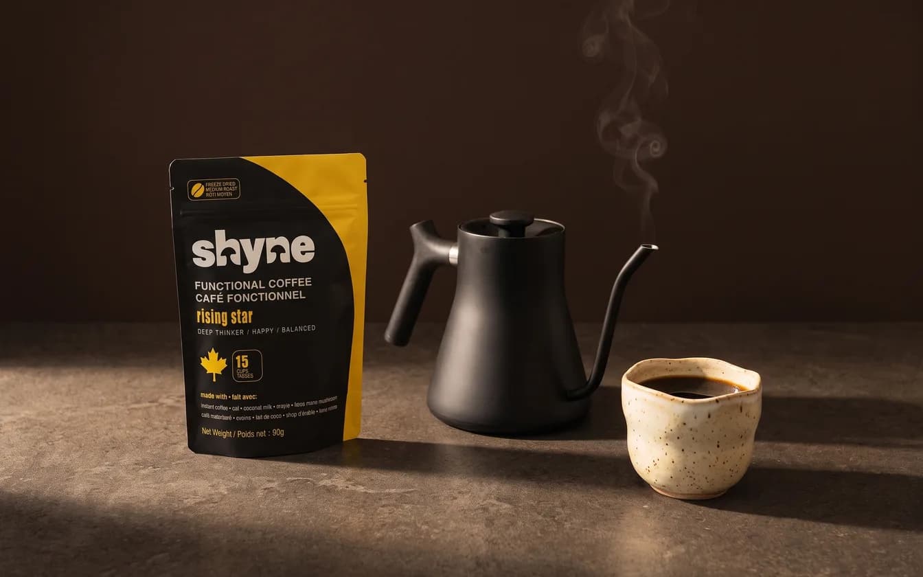 A pouch of Shyne, a kettle and a pottery cup of coffee
