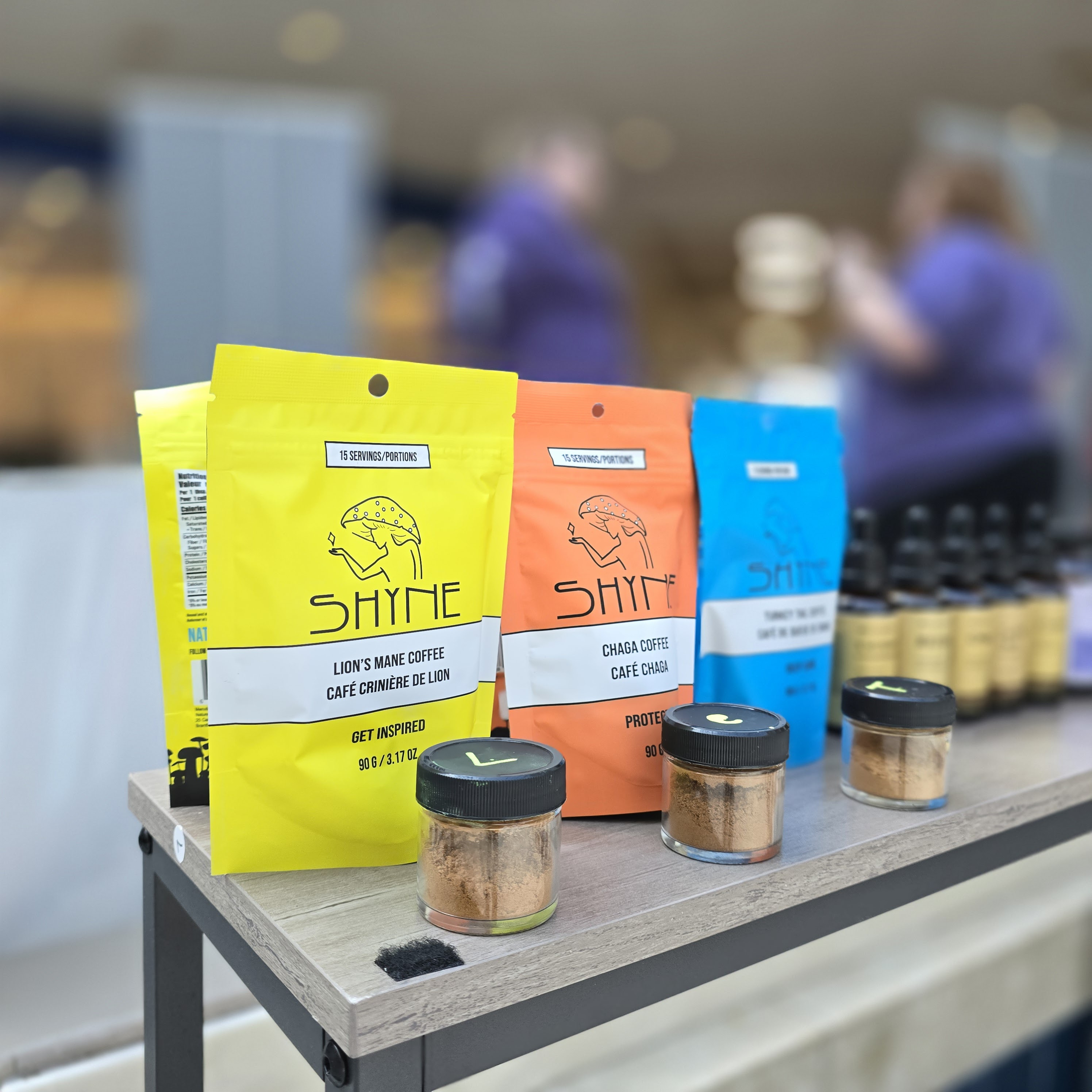 Shyne coffee trio at farmers market display with extract jars